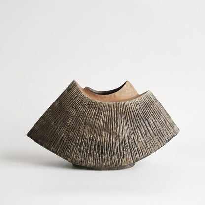Brown WabiSabi Ceramic Vase with a textured ridged exterior and fan-shaped silhouette, hero shot on a clean off-white background