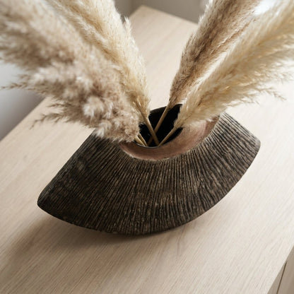 Close-up of the brown WabiSabi Ceramic Vase's opening with dried pampas grass stems on a console table