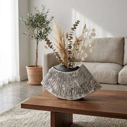 Black WabiSabi Ceramic Vase filled with dried branches and lotus pods in a neutral living room