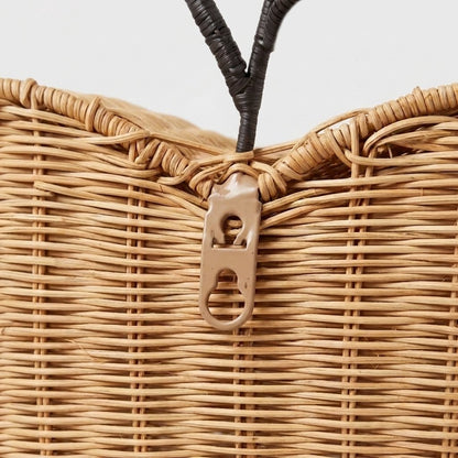 Close-up of the built-in keyhole mounting bracket on the back of the apple-shaped rattan basket