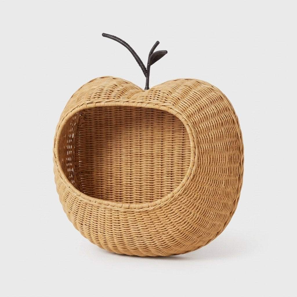 Apple-shaped handwoven rattan wall-mounted fruit storage basket on a white background