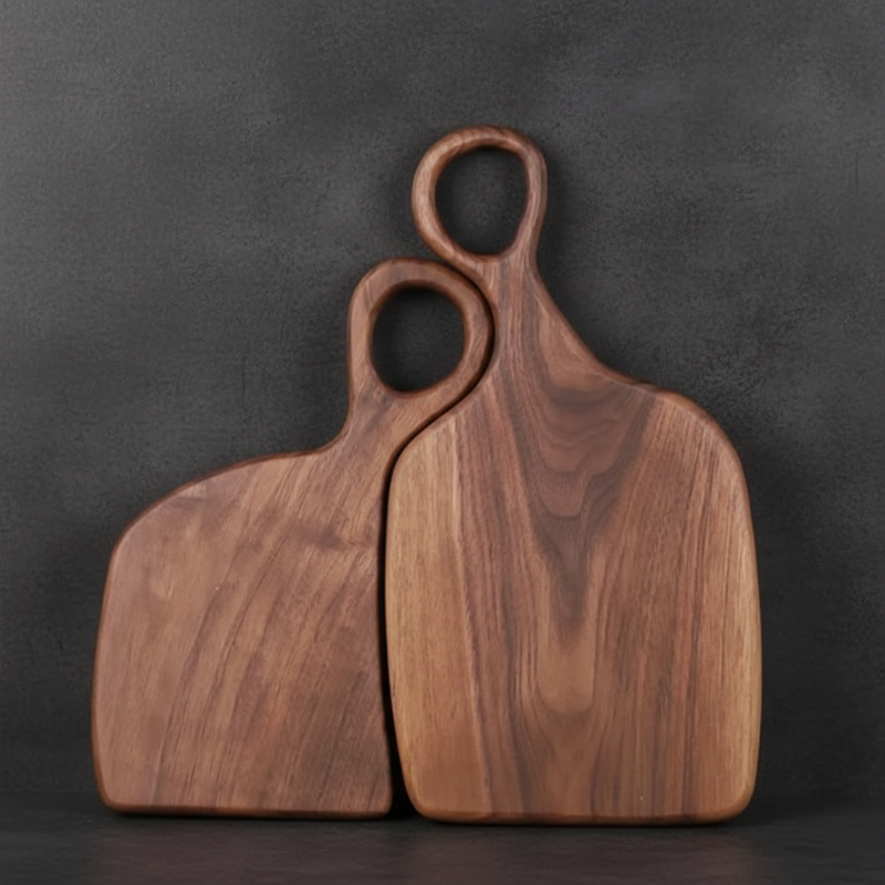 Two wooden cutting boards with handles on a dark background