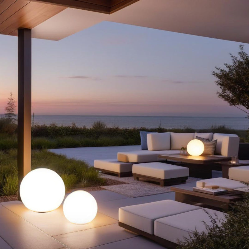 Outdoor patio with modern furniture and lighting overlooking a scenic landscape.