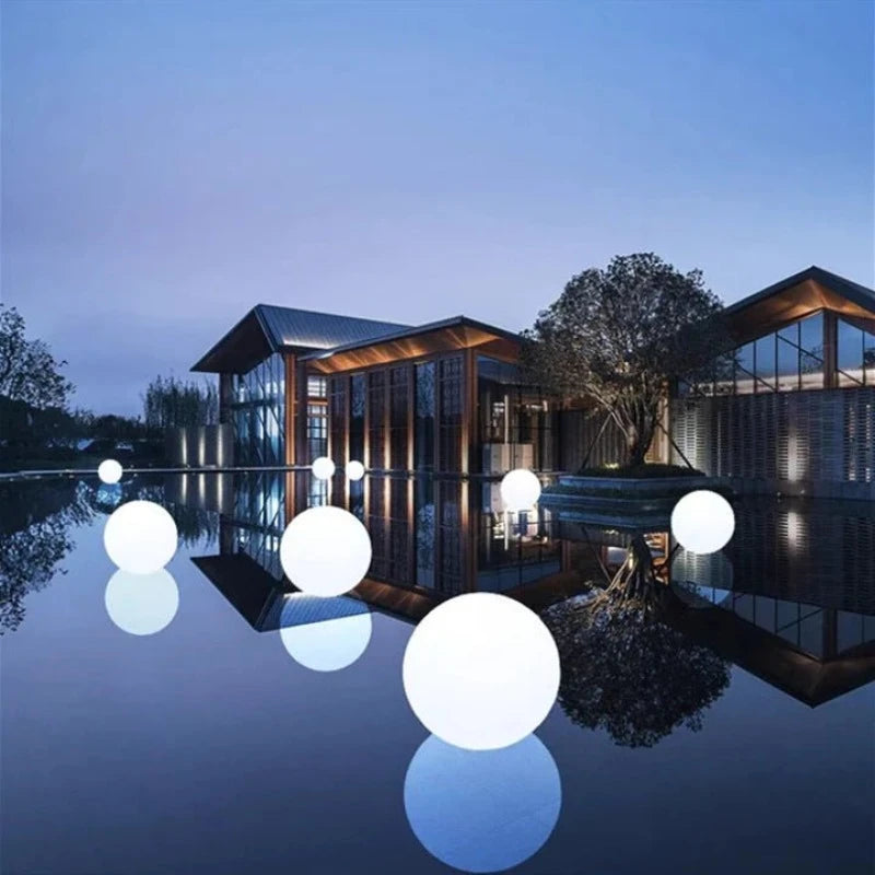 Stylish garden ball lights installed along garden walkways for added charm.