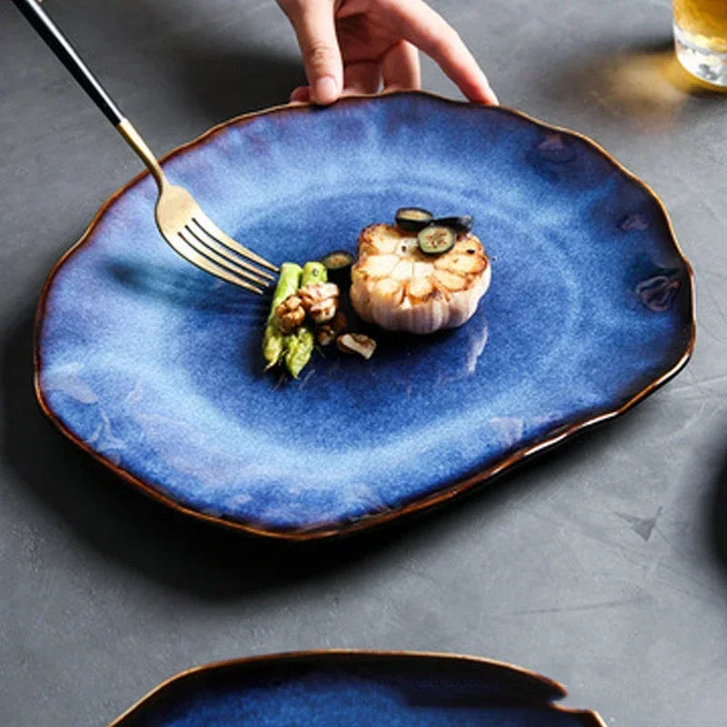 Wave Dinnerware pieces stacked neatly, emphasizing the smooth glaze and deep blue hue for a modern European-inspired look.