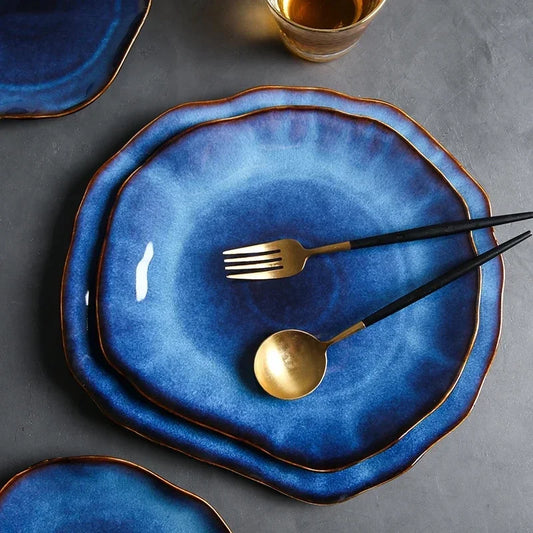 Elegant Wave Dinnerware set with irregular-shaped blue ceramic plates, perfect for modern dining aesthetics.