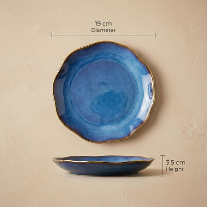 Blue ceramic plate with gold rim and measurements on a beige background