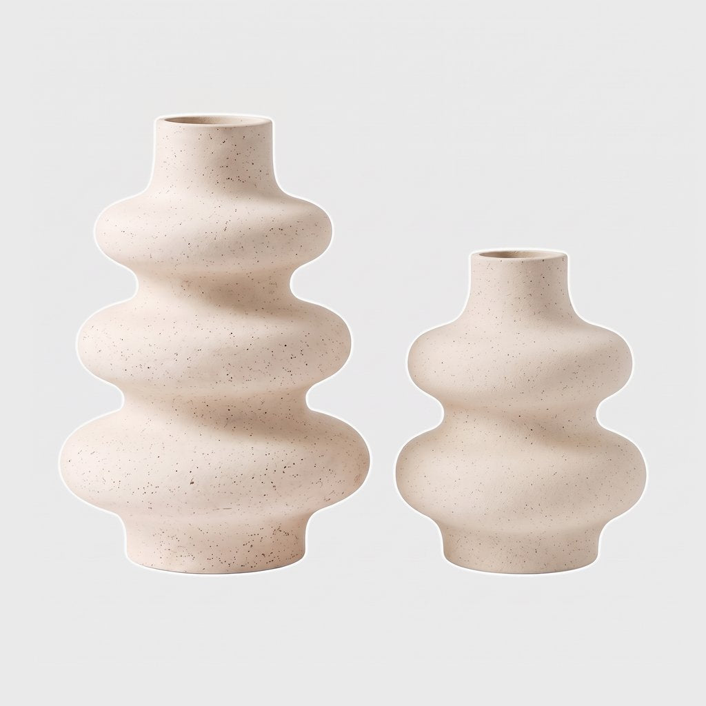 Large and medium cream rippled ceramic vases side by side on a plain light background