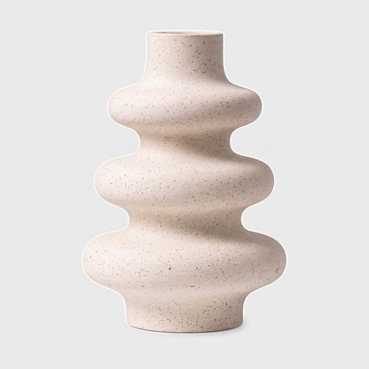 Large cream rippled ceramic vase with a speckled finish on a plain light background
