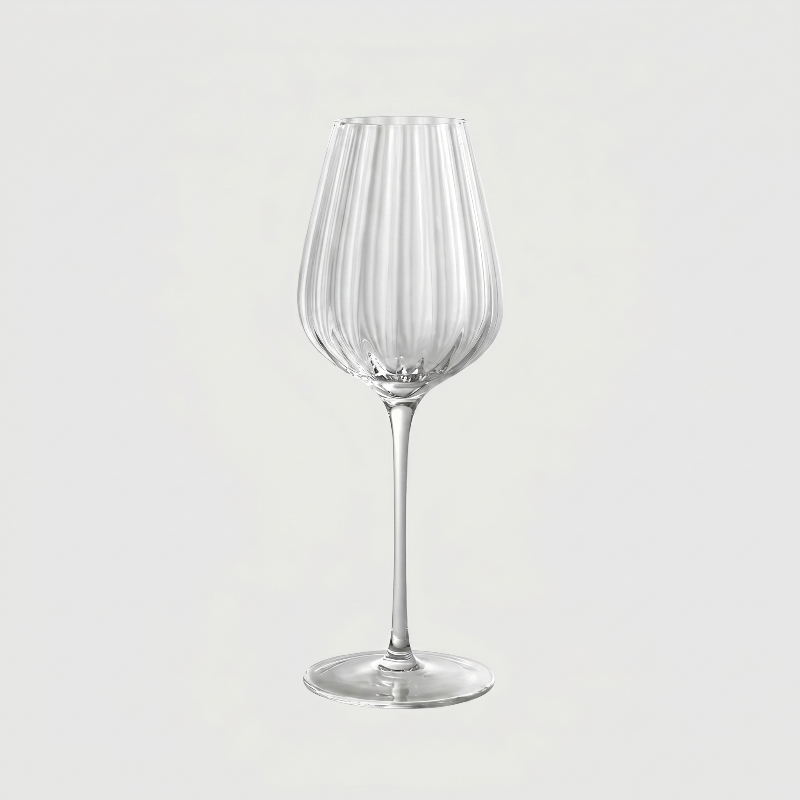 Clear wine glass on a light gray background