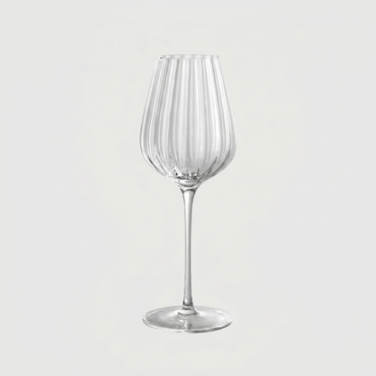 Clear wine glass on a light gray background