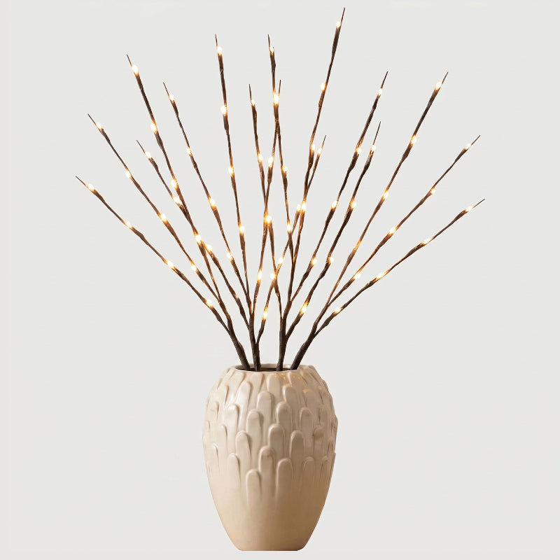 Willow branch LED lights in beige vase on white background