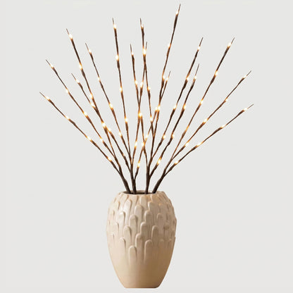 Willow branch LED lights in beige vase on white background
