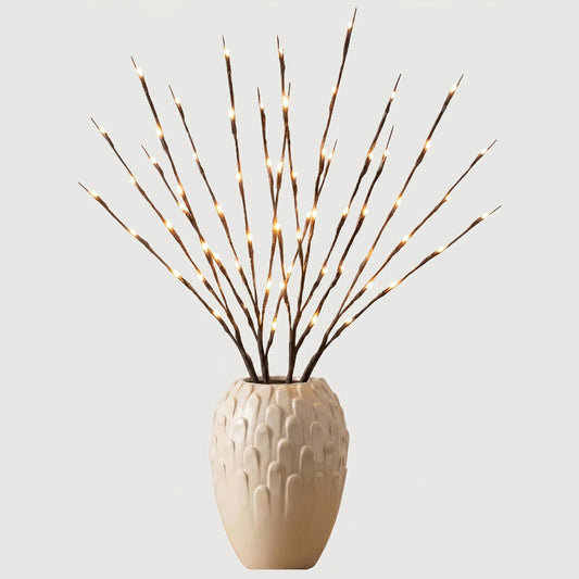 Willow branch LED lights in beige vase on white background