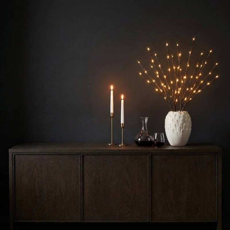 Willow branch LED lights in vase on dark console table