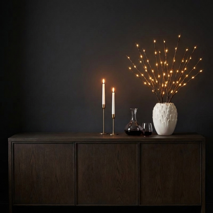 Willow branch LED lights in vase on dark console table