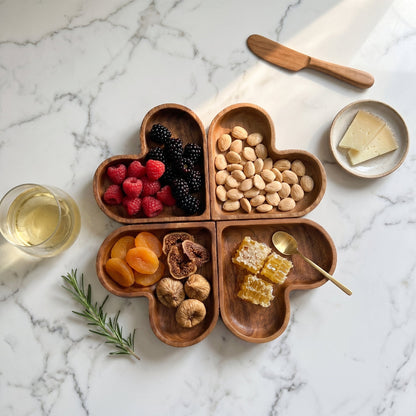 Wood heart-shaped dishes on white background with divided sections