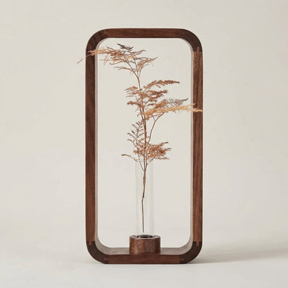 Decorative wooden frame with a plant inside on a plain background