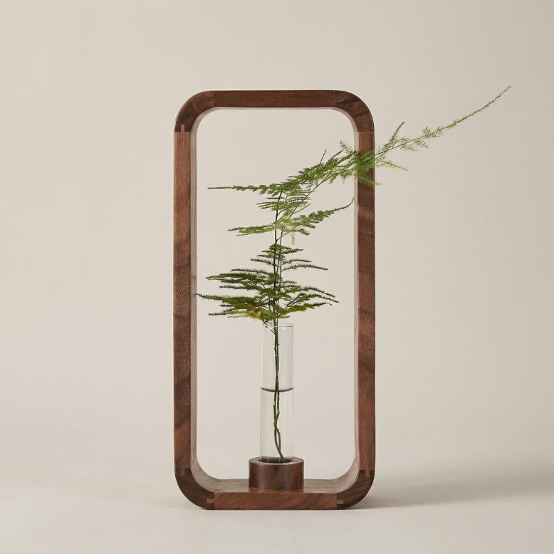 Decorative wooden frame with a glass vase containing a plant on a beige background