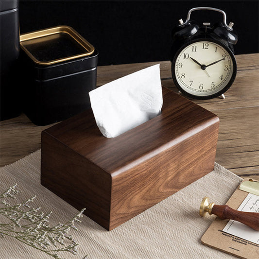 Wood tissue box styled on a desk with a clock and some flowers.