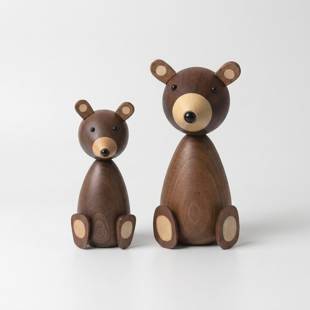 Small and large wooden bear figurines side by side on a plain light background
