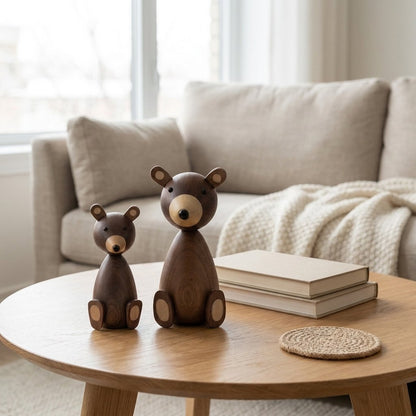 Small and large wooden bear figurines on a round oak coffee table with stacked books in a bright living room