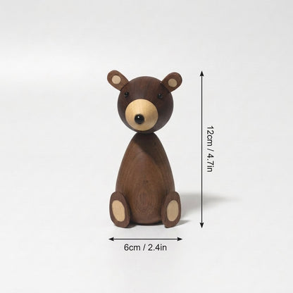 Small wooden bear figurine with arrows showing its height of 12 cm and width of 6 cm
