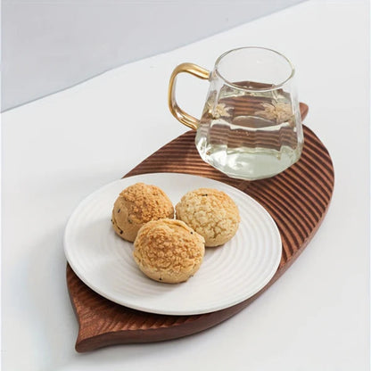 The wooden tray with an assortment of snacks, emphasizing its versatility for both decor and dining.