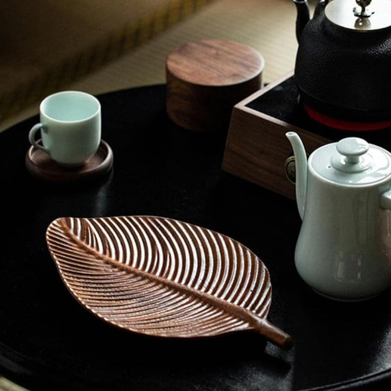 Elegant wooden tray with leaf motif, perfect for serving or displaying items.