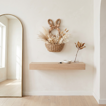 Woven bunny wall basket above floating shelf in neutral entryway