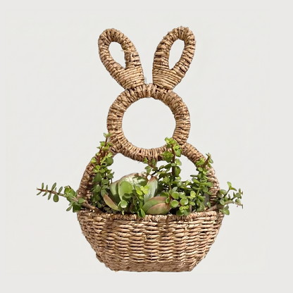 Woven bunny wall basket on white background with greenery