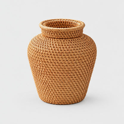 Honey toned woven rattan vase with a rounded body and a flared rim on a light grey background