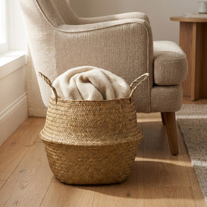 Woven seagrass basket with a throw blanket next to an armchair, Kiyo Home