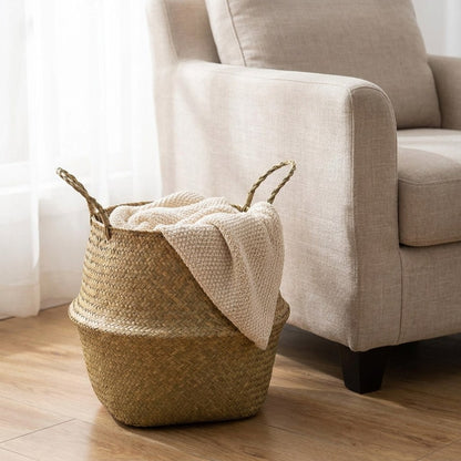 Woven seagrass basket with a blanket beside an armchair, Kiyo Home
