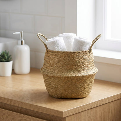 Woven seagrass basket with a towel on a bathroom counter, Kiyo Home