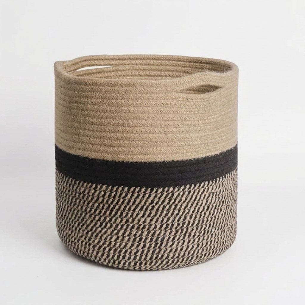 Woven Storage Basket in black and tan two-tone cotton rope with handles, front view on a clean off-white background