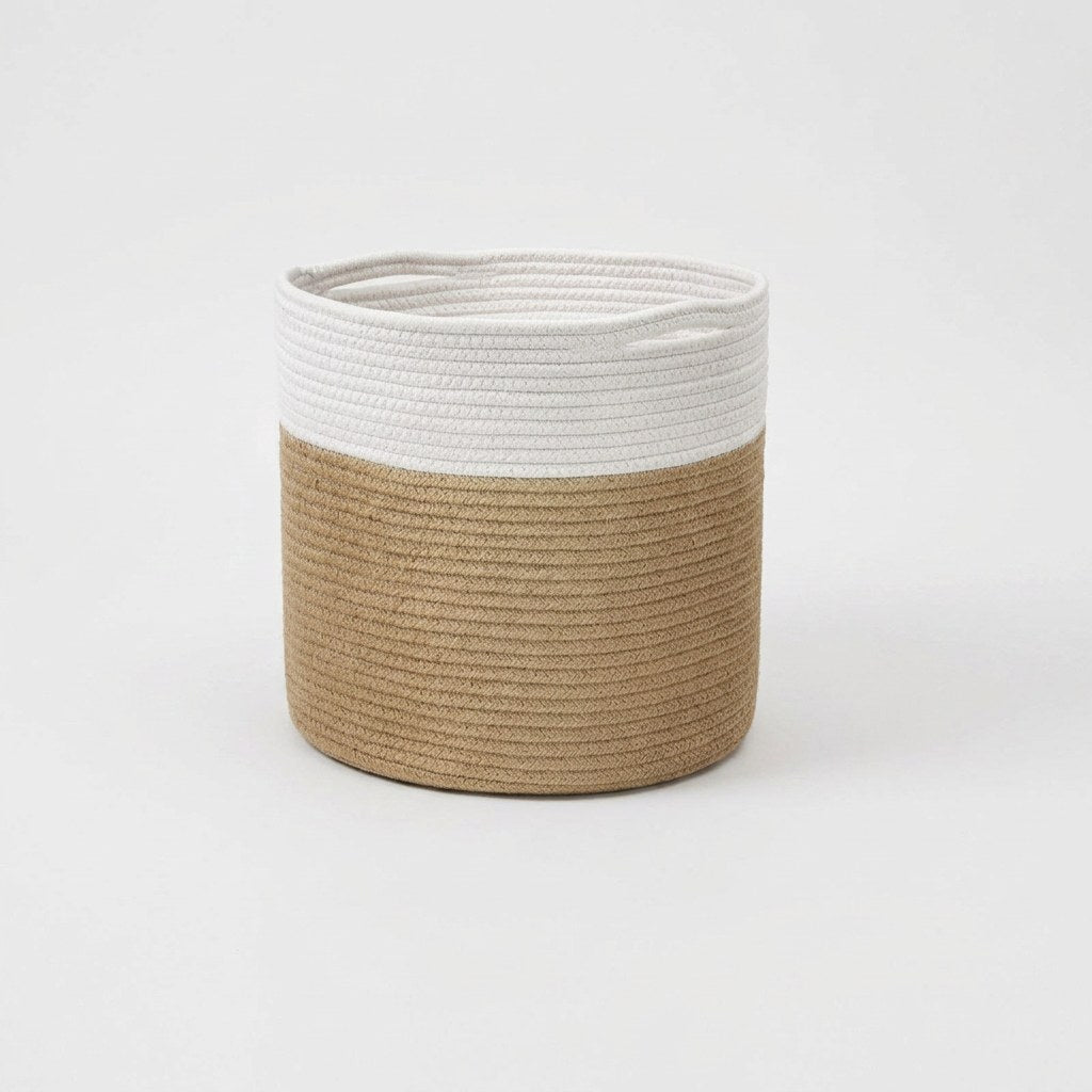 Woven Storage Basket in white and tan two-tone cotton rope with handles, front view on a clean off-white background