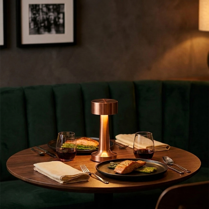 Zain cordless rechargeable table lamp in black on dining table in moody setting
