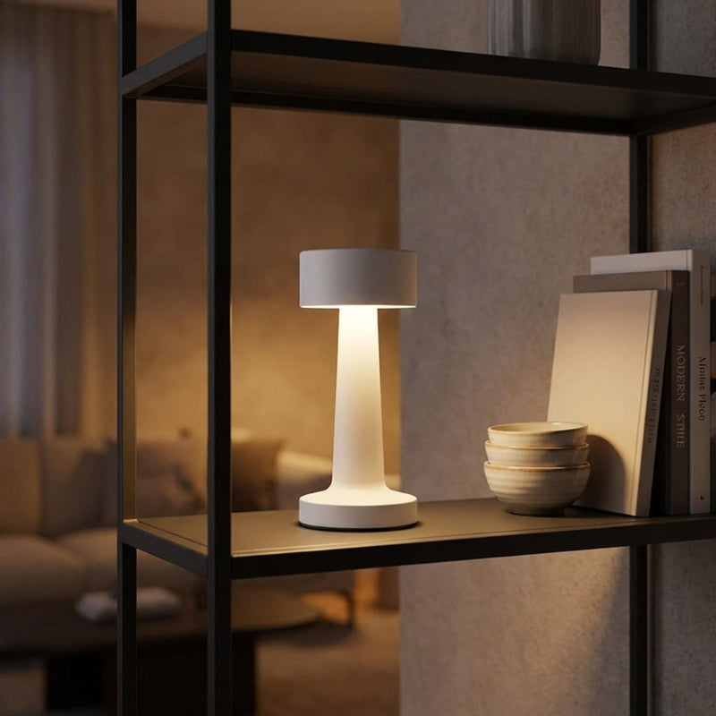 Zain cordless rechargeable table lamp in gold on dining table by window at dusk
