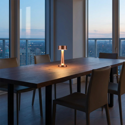 Zain cordless rechargeable table lamp in rose gold on outdoor dining table with wine glasses