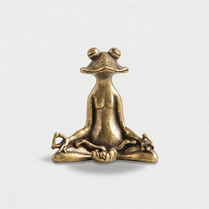Zen frog figurine in antique brass finish on white background